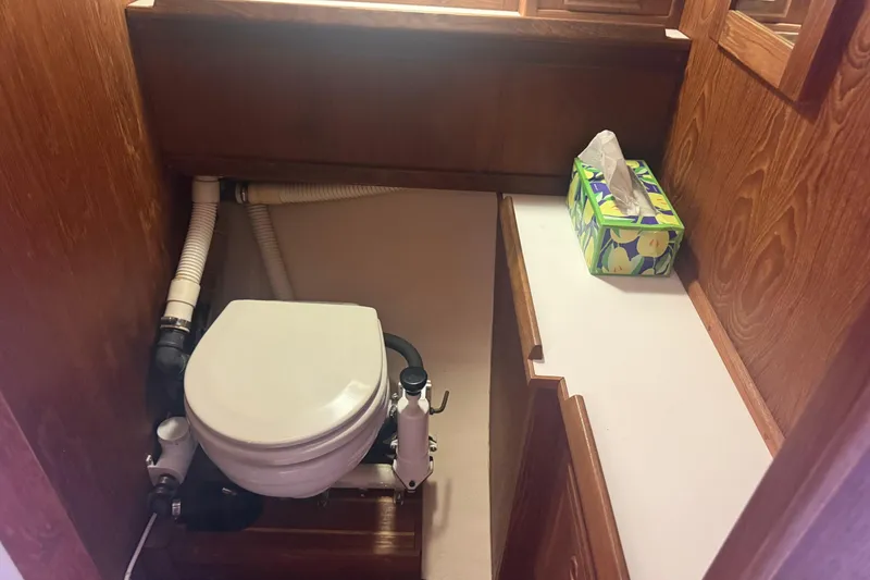 Slide: The Image of Boat bathroom with marine toilet and tissue box, Abbott 36, 1986 model. - 34