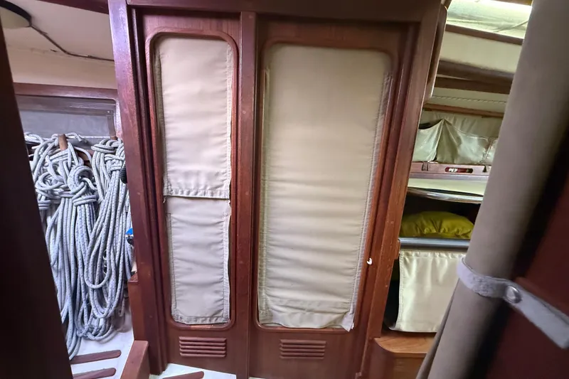 Slide: The Image of Interior of 1986 Abbott 36 sailboat with ropes and wooden cabinetry. - 36