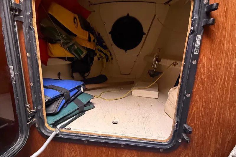 Slide: The Image of Interior cabin view of a 1986 Abbott 36 sailboat with life jackets and storage. - 38