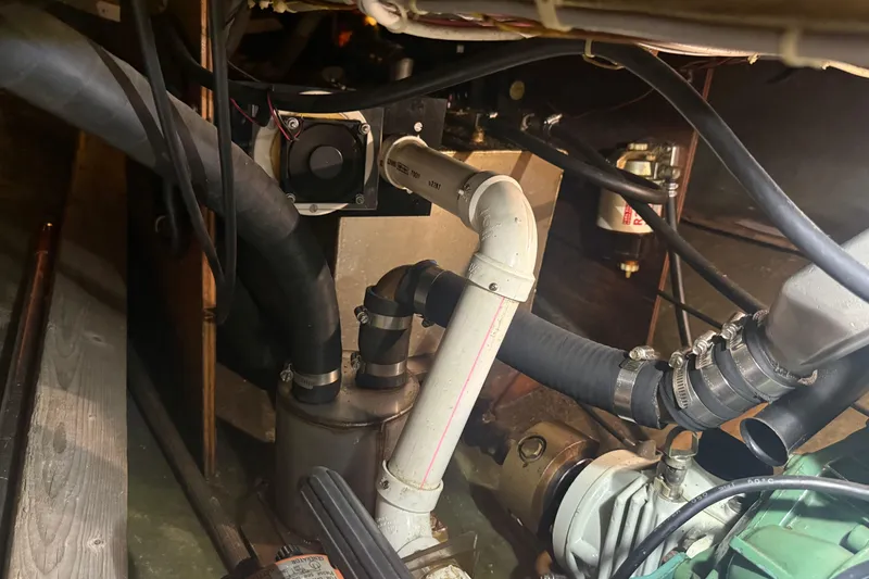 Slide: The Image of Engine compartment of a 1986 Abbott 36 sailboat, showing hoses and mechanical components. - 39