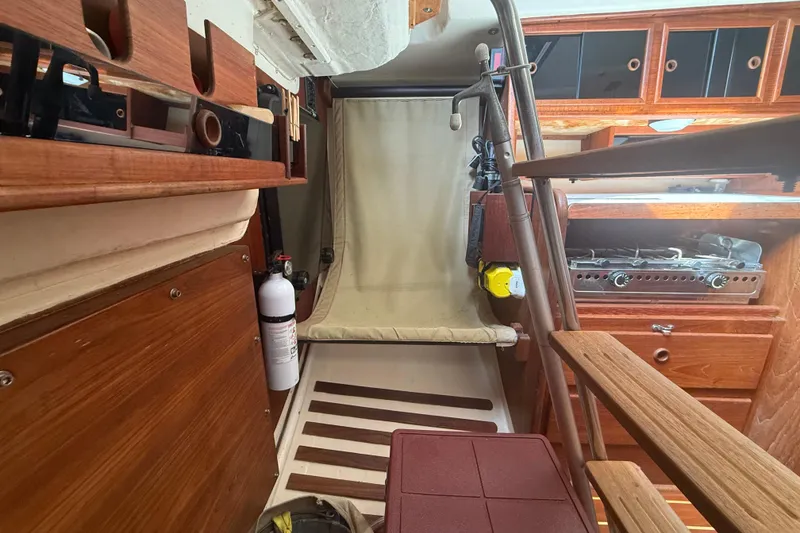Slide: The Image of Interior of 1986 Abbott 36 sailboat with wooden cabinetry and compact kitchen area. - 41