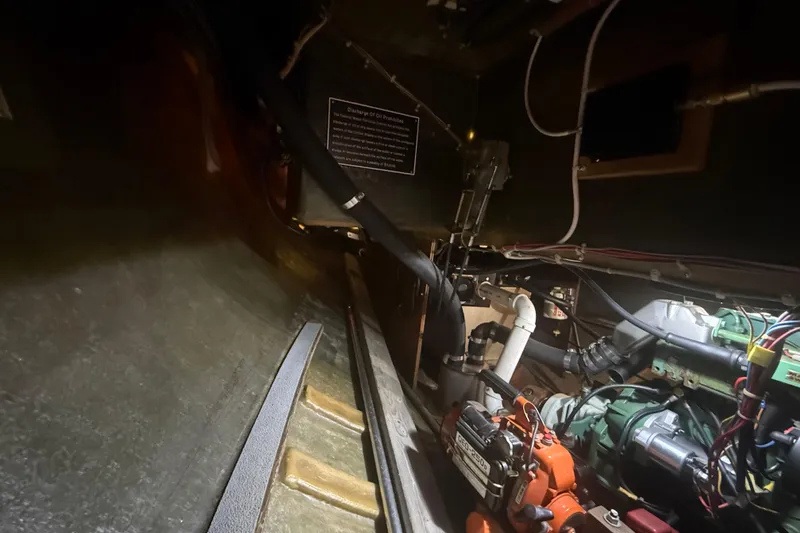 Slide: The Image of Engine room of a 1986 Abbott 36 sailboat with visible machinery and wiring. - 43