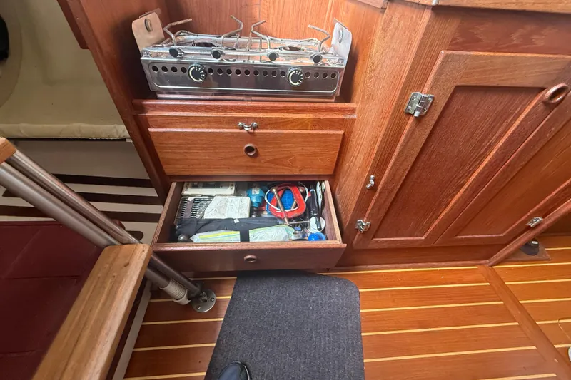 Slide: The Image of Wooden boat interior with stove and open drawer, Abbott 36, 1986 model. - 47