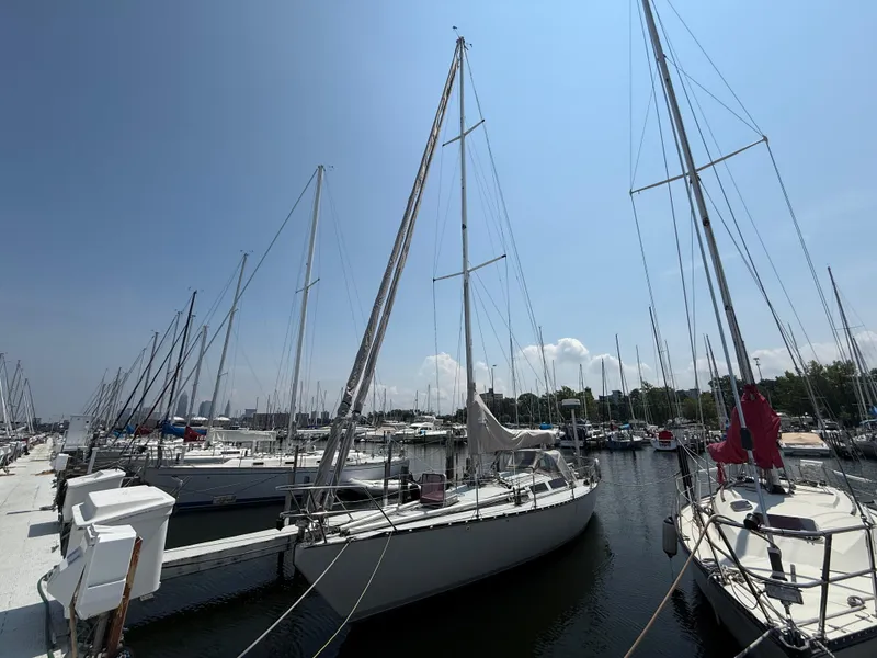Slide: The Image of Sailboats docked at a marina under a clear blue sky, featuring an Abbott 36 from 1986. - 5