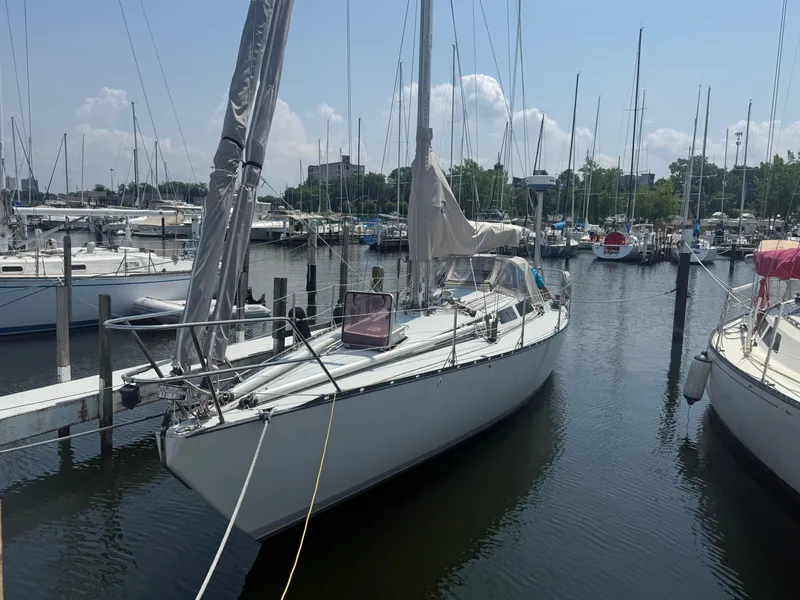 Slide: The Image of 1986 Abbott 36 sailboat docked in a marina under a clear blue sky. - 6