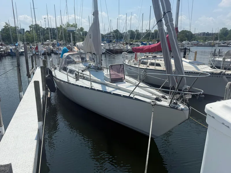 Slide: The Image of 1986 Abbott 36 sailboat docked at marina, surrounded by other boats on a sunny day. - 8