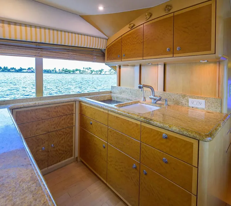 Slide: The Image of Luxurious kitchen interior of 2003 Ocean Yachts 62 Enclosed Bridge Super Sport with ocean view. - 16