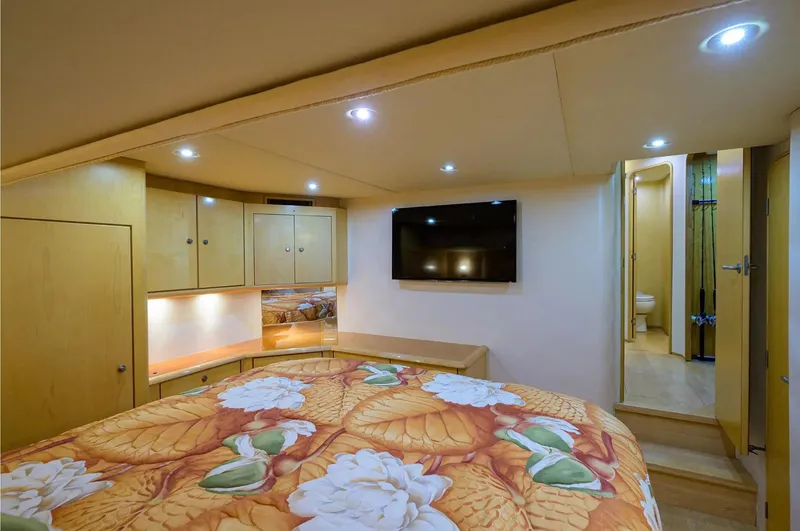 Slide: The Image of Luxurious bedroom in 2003 Ocean Yachts 62 Enclosed Bridge Super Sport with floral bedding. - 20