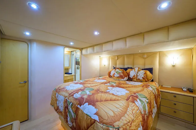 Slide: The Image of Luxurious bedroom in 2003 Ocean Yachts 62 Enclosed Bridge Super Sport with floral bedding. - 22