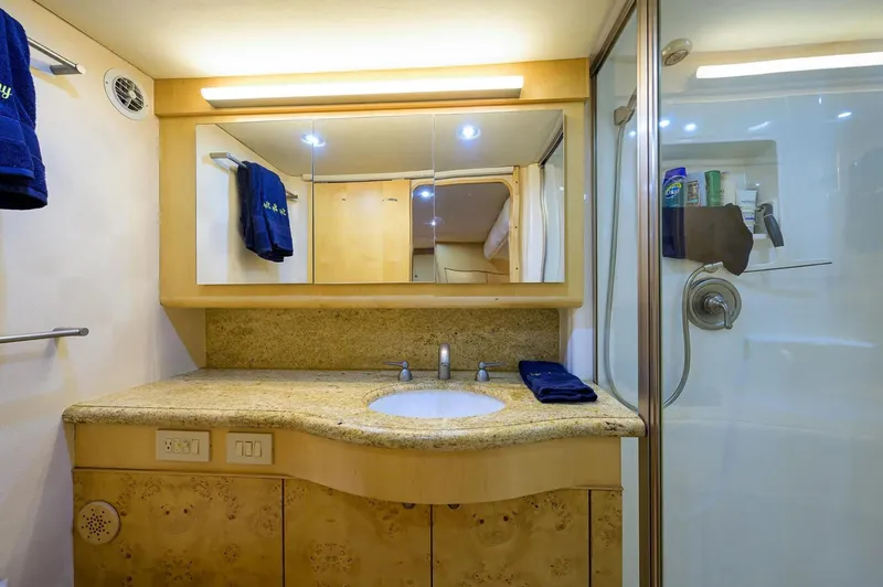 Slide: The Image of Luxurious bathroom in 2003 Ocean Yachts 62 Enclosed Bridge Super Sport, featuring elegant fixtures. - 23
