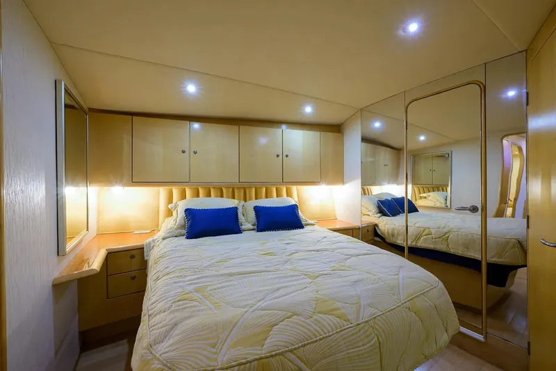Slide: The Image of Luxurious bedroom in 2003 Ocean Yachts 62 Enclosed Bridge Super Sport, featuring elegant lighting and decor. - 28