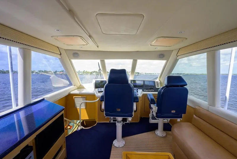 Slide: The Image of Interior of 2003 Ocean Yachts 62 Enclosed Bridge Super Sport, featuring helm and seating. - 40