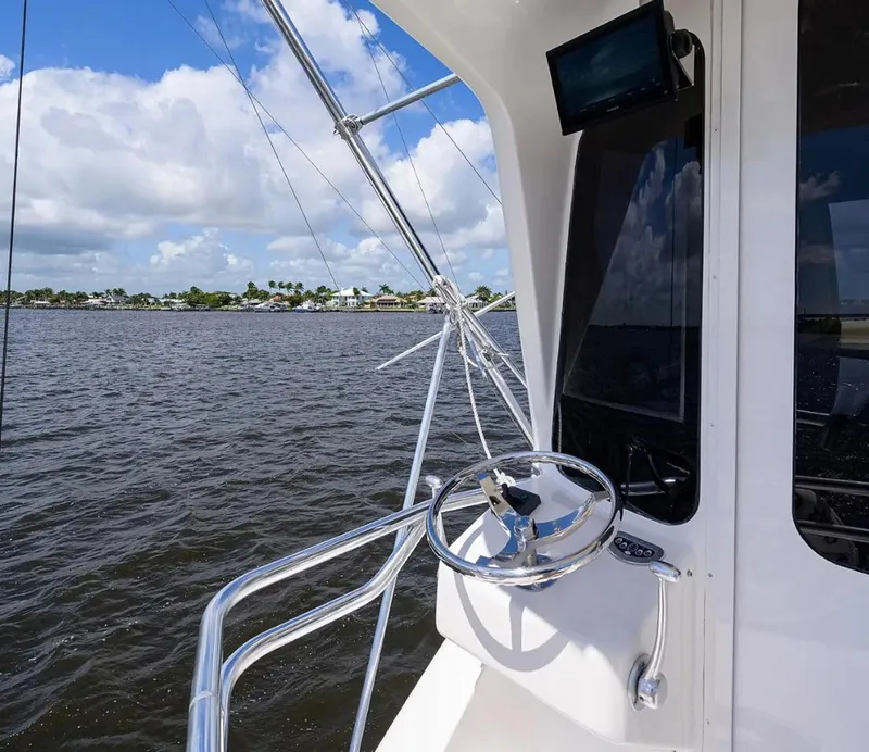 Slide: The Image of 2003 Ocean Yachts 62 Enclosed Bridge Super Sport steering area with ocean view. - 45