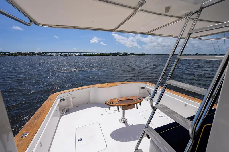 Slide: The Image of 2003 Ocean Yachts 62 Enclosed Bridge Super Sport, spacious deck overlooking serene waters. - 47