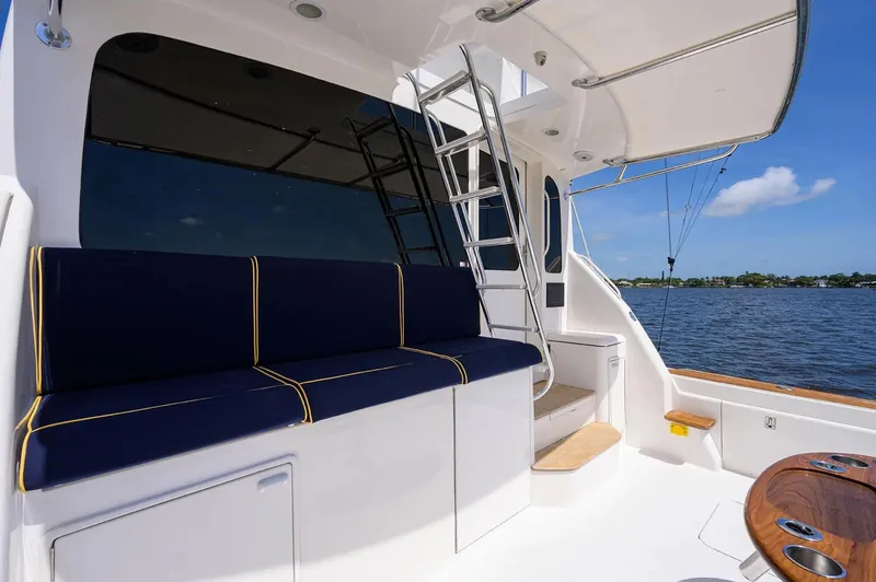 Slide: The Image of 2003 Ocean Yachts 62 Enclosed Bridge Super Sport, featuring a spacious deck with seating. - 49