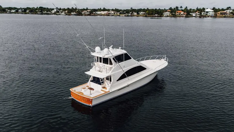 Slide: The Image of 2003 Ocean Yachts 62 Enclosed Bridge Super Sport on calm water, distant shoreline. - 6