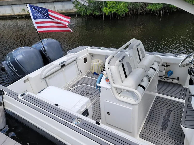 Slide: The Image of 2008 Everglades 290 CC boat with American flag, dual engines, and spacious seating. - 3