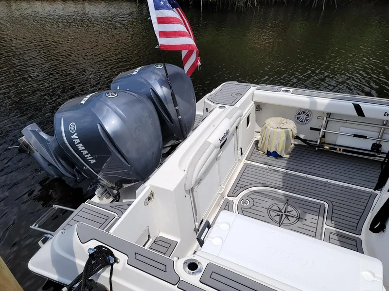 Slide: The Image of 2008 Everglades 290 CC boat with Yamaha engines and American flag on calm water. - 5
