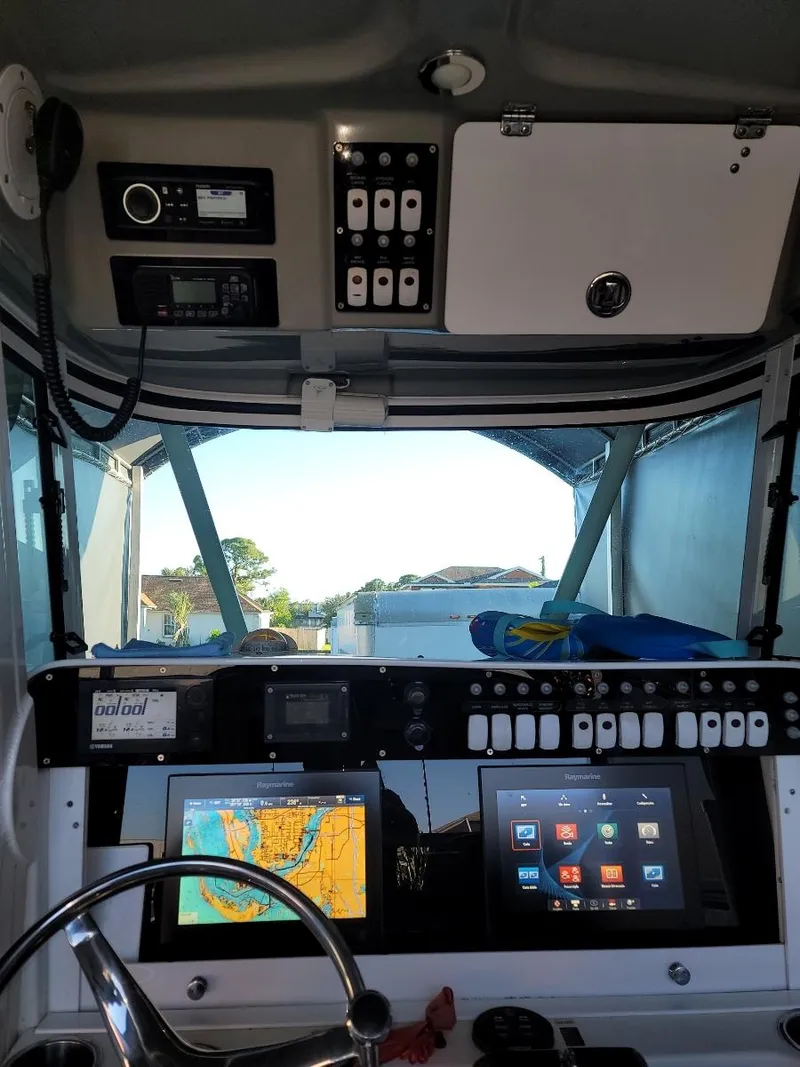 Slide: The Image of 2008 Everglades 290 CC boat cockpit with navigation and control panels. - 7