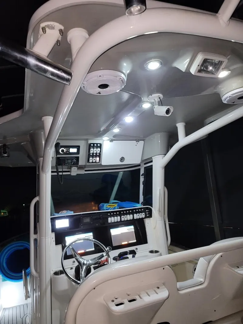 Slide: The Image of 2008 Everglades 290 CC boat interior with illuminated dashboard and modern controls. - 8