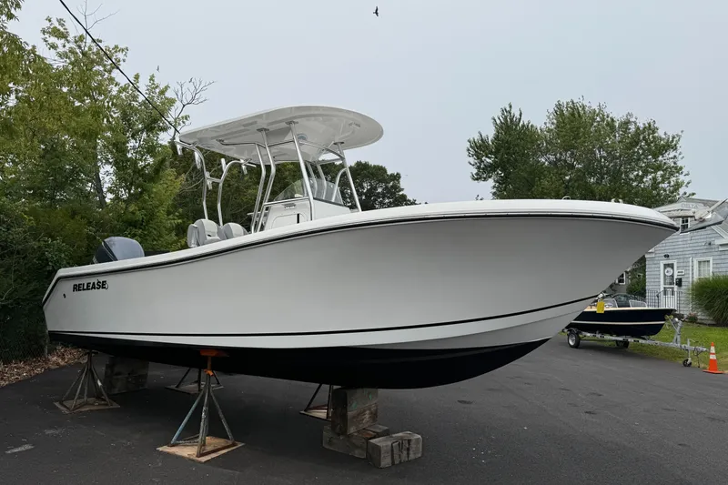 Slide: The Image of 2020 Release 240 R boat on stands, white hull, outdoor setting. - 0