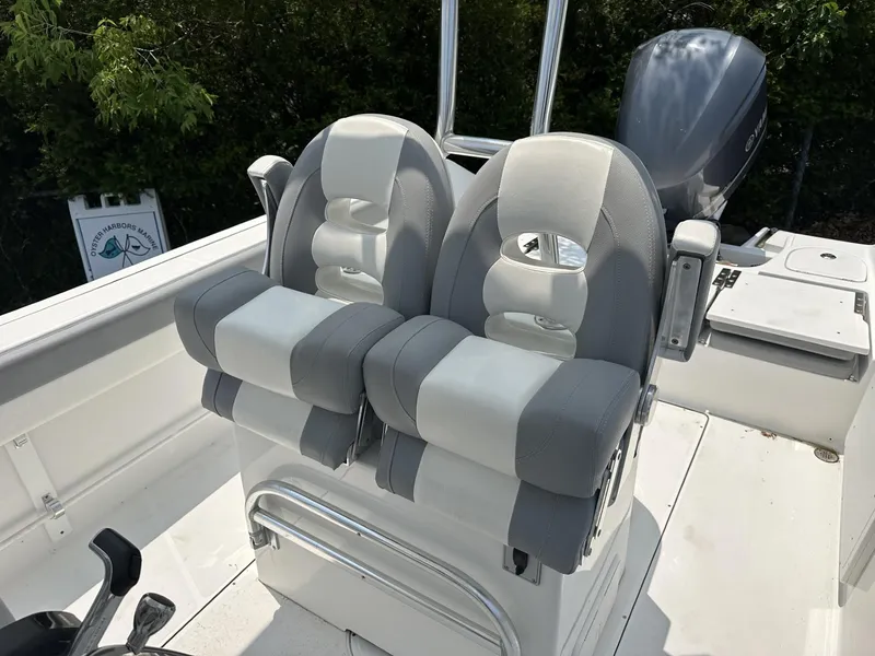 Slide: The Image of 2020 Release 240 R boat seats, gray and white, with outboard motor in background. - 11