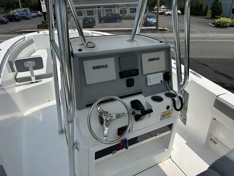 Slide: The Image of Center console of 2020 Release 240 R boat with Simrad electronics and steering wheel. - 13