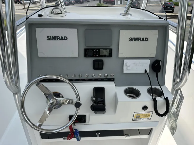 Slide: The Image of Boat console with dual Simrad displays, steering wheel, and controls, Release 240 R, 2020 model. - 14