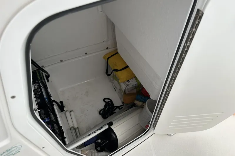 Slide: The Image of Storage compartment of 2020 Release 240 R boat with equipment and supplies. - 19