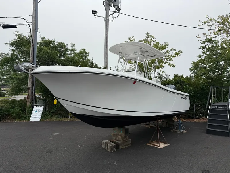 Slide: The Image of 2020 Release 240 R boat on display, elevated on blocks, surrounded by greenery. - 2