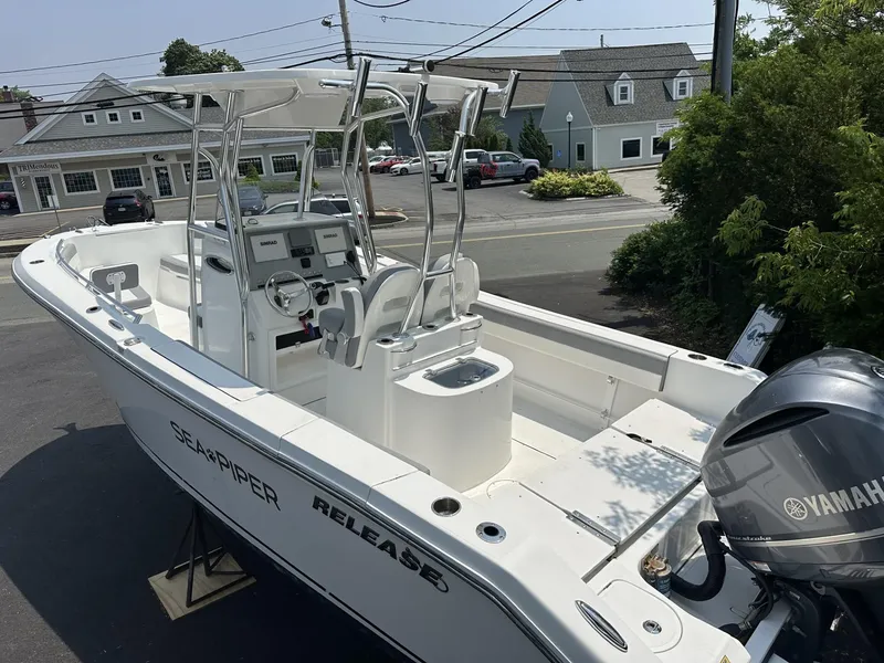 Slide: The Image of 2020 Release 240 R boat with Yamaha engine, parked outdoors near buildings. - 5