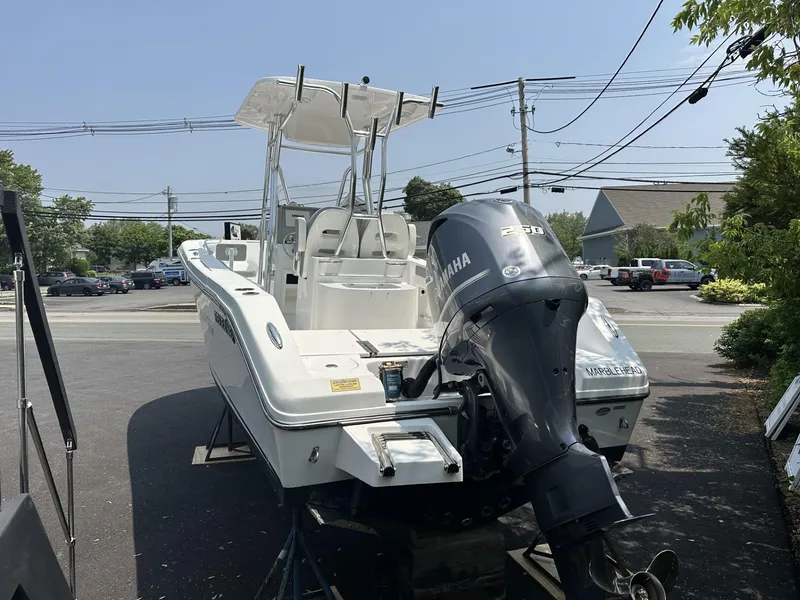 Slide: The Image of 2020 Release 240 R boat with Yamaha outboard motor, parked outdoors. - 6