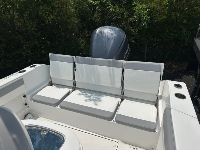 Slide: The Image of 2020 Release 240 R boat with white seating and outboard motor, surrounded by greenery. - 8