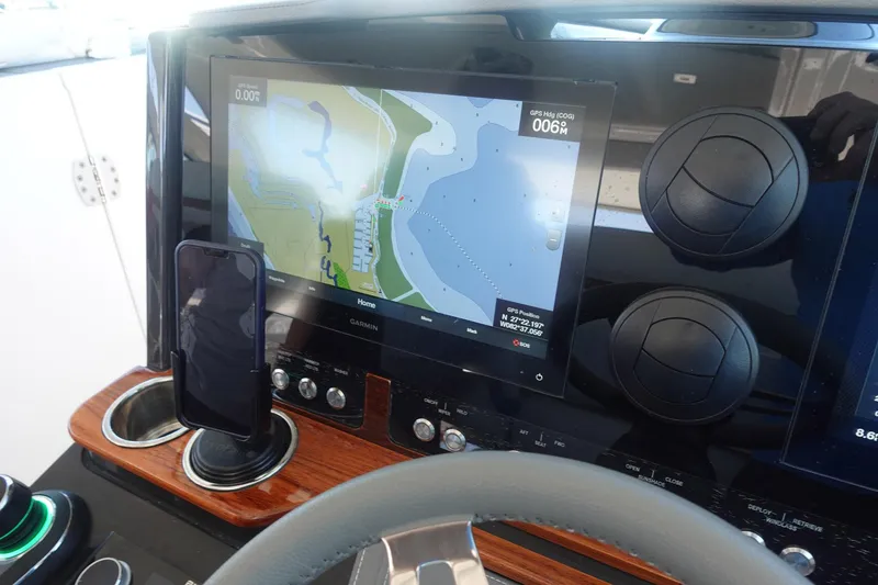 Slide: The Image of Dashboard of 2020 Tiara Sport 38 LX with navigation display and smartphone holder. - 15