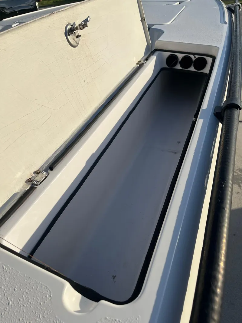 Slide: The Image of Open storage compartment on a 2002 Back Country 201 Pro Guide boat. - 10