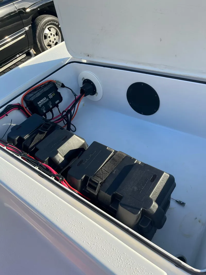 Slide: The Image of Battery compartment of a 2002 Back Country 201 Pro Guide boat, showing wiring and battery boxes. - 11