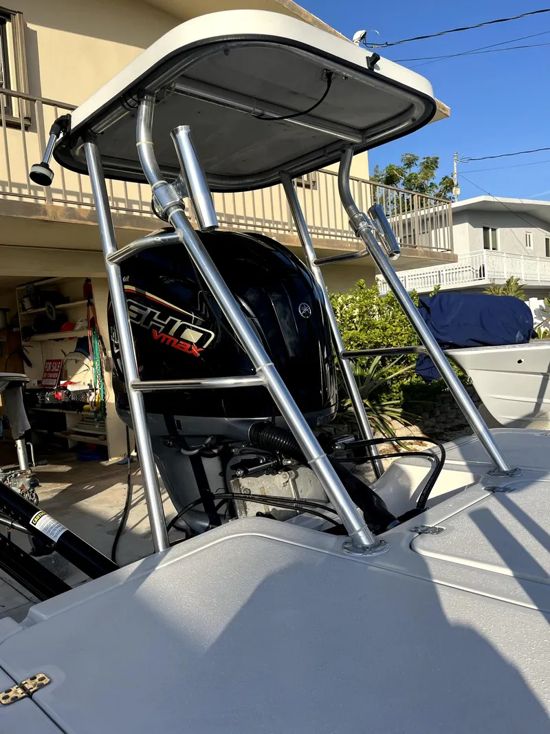 Slide: The Image of 2002 Back Country 201 Pro Guide boat with T-top and powerful outboard motor. - 2