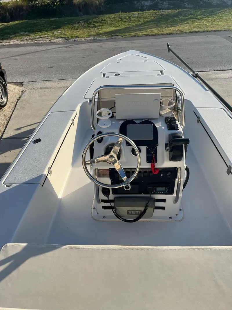 Slide: The Image of 2002 Back Country 201 Pro Guide boat with steering console, docked on a sunny day. - 7