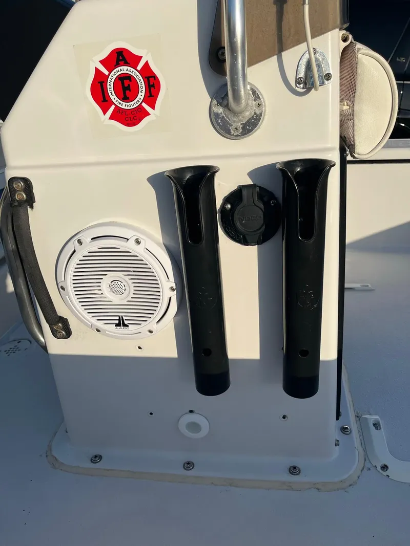 Slide: The Image of 2002 Back Country 201 Pro Guide boat console with rod holders and speaker. - 8