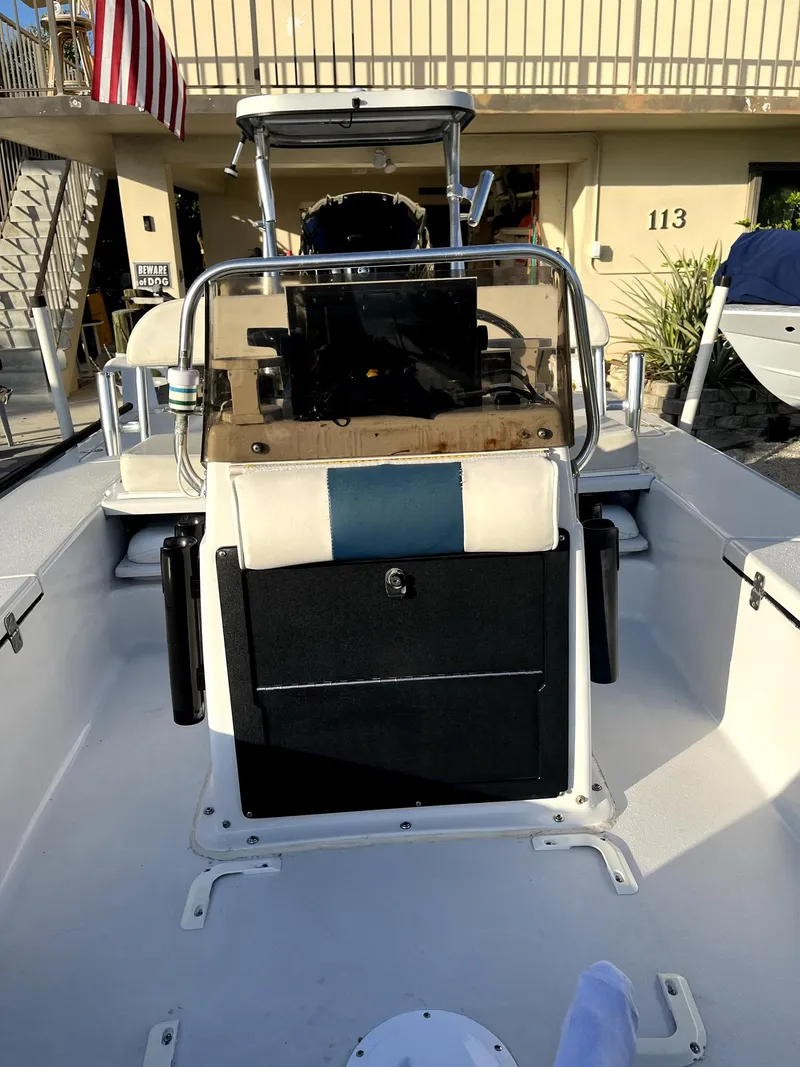 Slide: The Image of 2002 Back Country 201 Pro Guide boat, center console, docked with American flag in background. - 9