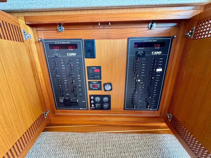 Slide: The Image of Electrical panel of 2002 Cabo 47 Flybridge Sportfisher with wooden cabinet. - 14