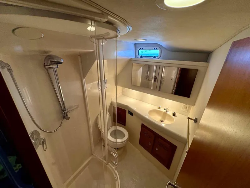 Slide: The Image of 2002 Cabo 47 Flybridge Sportfisher bathroom with shower, sink, and toilet. - 19