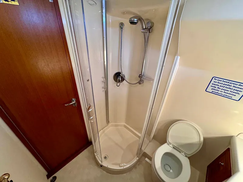 Slide: The Image of Bathroom interior of 2002 Cabo 47 Flybridge Sportfisher with shower and toilet. - 20