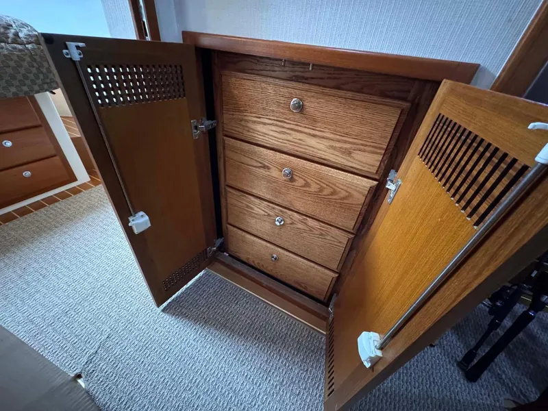 Slide: The Image of Wooden cabinet with four drawers inside a 2002 Cabo 47 Flybridge Sportfisher boat. - 24