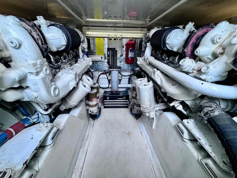 Slide: The Image of Engine room of 2002 Cabo 47 Flybridge Sportfisher with dual engines and equipment. - 28