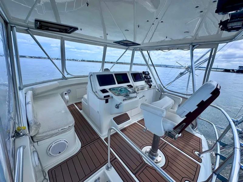 Slide: The Image of 2002 Cabo 47 Flybridge Sportfisher helm with navigation equipment and ocean view. - 30