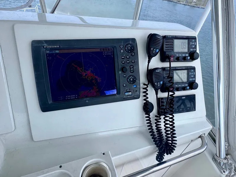 Slide: The Image of Control panel of 2002 Cabo 47 Flybridge Sportfisher with navigation and communication equipment. - 39