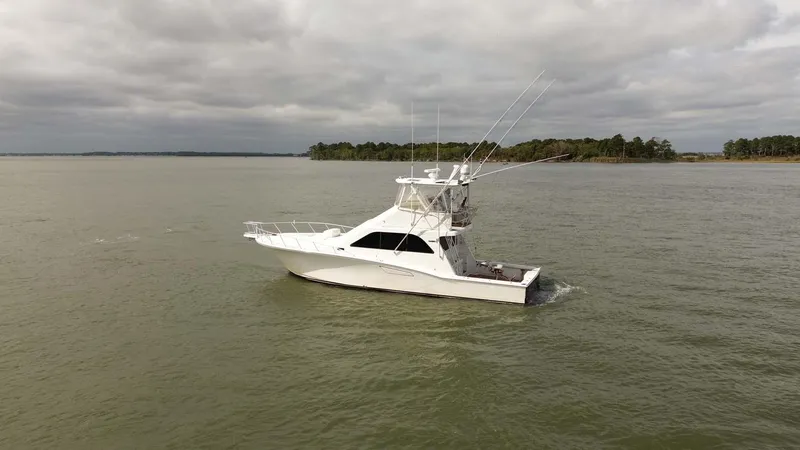 Slide: The Image of 2002 Cabo 47 Flybridge Sportfisher cruising on a calm, cloudy day. - 5
