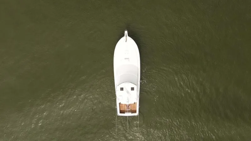 Slide: The Image of Aerial view of 2002 Cabo 47 Flybridge Sportfisher on calm water. - 9