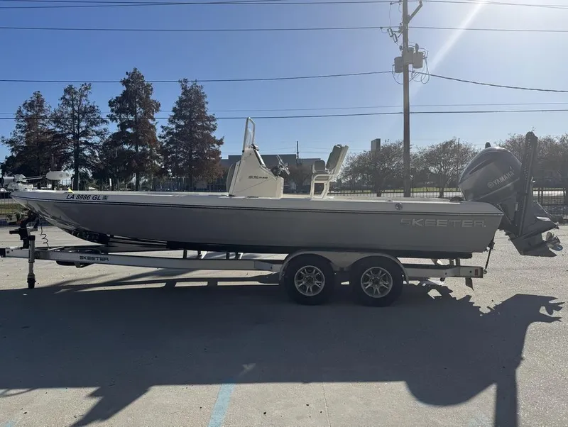 Slide: The Image of 2019 Skeeter SX 240 boat on trailer, parked outdoors, side view. - 11